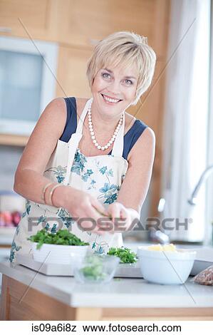 Woman cooking in kitchen View Large Photo Image Stock Photo - Woman cooking in kitchen. Fotosearch