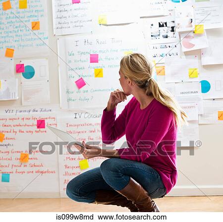 Woman crouching with digital tablet View Large Photo Image Stock Image - Woman crouching with digital tablet. Fotosearch