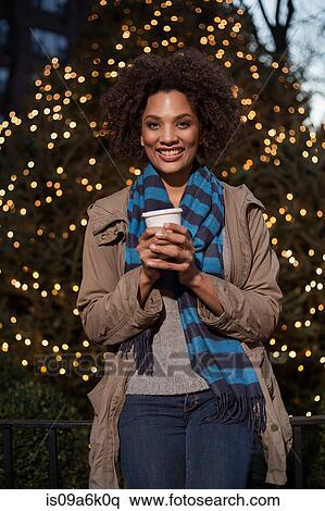 Woman having coffee on city street View Large Photo Image Stock Photography - Woman having coffee on city street. Fotosearch