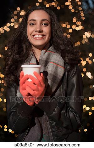 Stock Photography - Woman having coffee on city street. Fotosearch