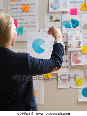 Woman holding paper with pie chart View Large Photo Image Stock Photography - Woman holding paper with pie chart. Fotosearch