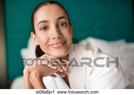 Woman in bathrobe smiling on bed View Large Photo Image Stock Photo - Woman in bathrobe smiling on bed. Fotosearch