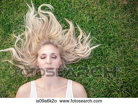 Woman laying in grass View Large Photo Image Picture - Woman laying in grass. Fotosearch