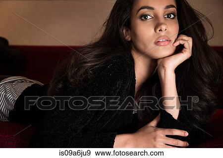 Woman laying on sofa View Large Photo Image Stock Photo - Woman laying on sofa. Fotosearch