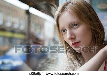 Picture - Woman leaning on window. Fotosearch