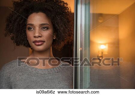 Woman looking out window View Large Photo Image Stock Photo - Woman looking out window. Fotosearch