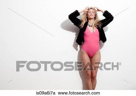 Stock Image - Woman modeling swimsuit and jacket. Fotosearch