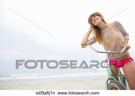 Woman on bicycle on beach View Large Photo Image Picture - Woman on bicycle on beach. Fotosearch