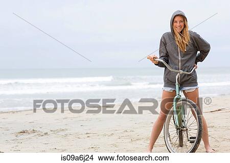 Woman on bicycle on beach View Large Photo Image Picture - Woman on bicycle on beach. Fotosearch