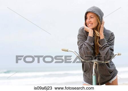 Woman on bicycle on beach View Large Photo Image Stock Image - Woman on bicycle on beach. Fotosearch