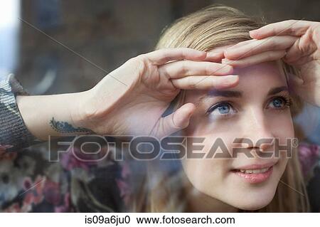 Woman peering through window View Large Photo Image Stock Image - Woman peering through window. Fotosearch
