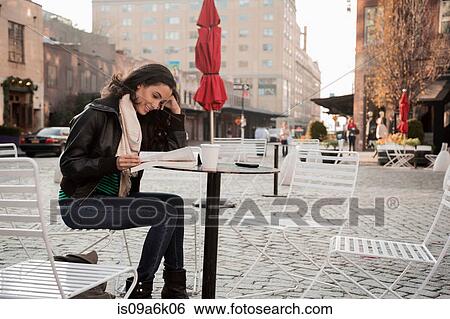 Woman reading at sidewalk cafe View Large Photo Image Stock Photograph - Woman reading at sidewalk cafe. Fotosearch