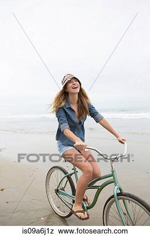 Woman riding bicycle on beach View Large Photo Image Stock Photo - Woman riding bicycle on beach. Fotosearch