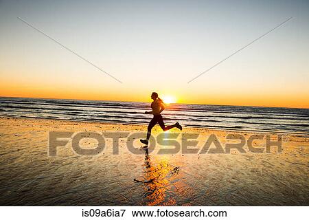 Stock Photo - Woman running on beach. Fotosearch