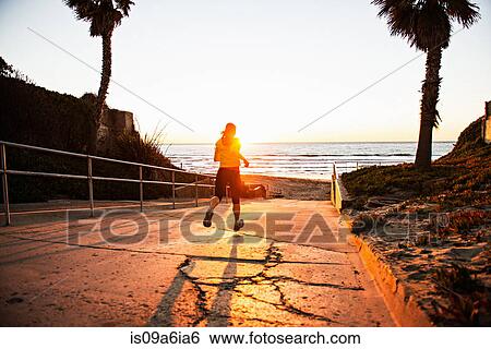 Woman running on hill path View Large Photo Image Stock Photograph - Woman running on hill path. Fotosearch