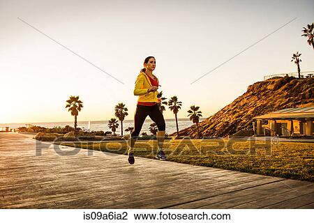 Woman running on wooden path View Large Photo Image Stock Image - Woman running on wooden path. Fotosearch