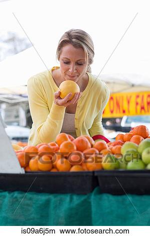 Woman shopping at farmer's market View Large Photo Image Picture - Woman shopping at farmer's market. Fotosearch