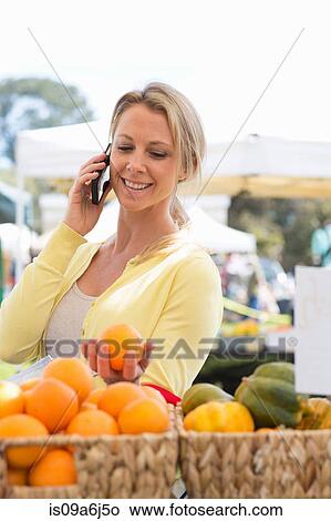 Picture - Woman shopping at farmer's market. Fotosearch