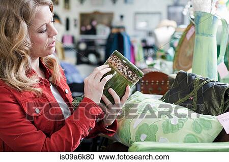 Woman shopping in thrift store View Large Photo Image Stock Image - Woman shopping in thrift store. Fotosearch