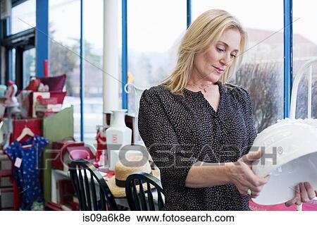 Woman shopping in thrift store View Large Photo Image Stock Image - Woman shopping in thrift store. Fotosearch