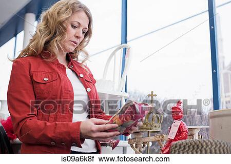 Woman shopping in thrift store View Large Photo Image Stock Image - Woman shopping in thrift store. Fotosearch