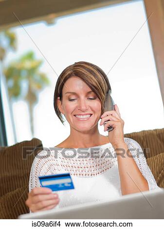 Woman shopping on telephone View Large Photo Image Picture - Woman shopping on telephone. Fotosearch