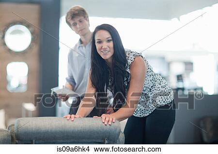 Picture - Woman shopping with salesman in store. Fotosearch