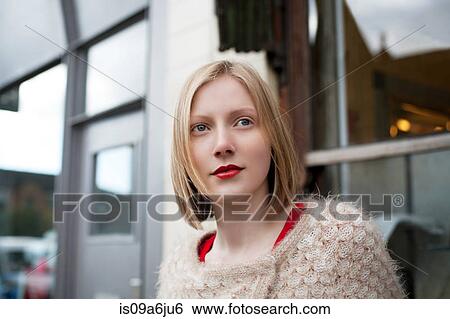 Woman standing on city street View Large Photo Image Stock Photograph - Woman standing on city street. Fotosearch