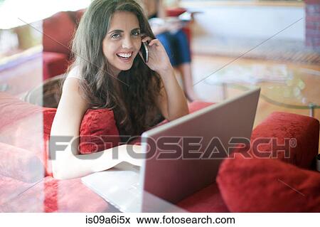 Woman talking on cell phone on sofa View Large Photo Image Stock Photo - Woman talking on cell phone on sofa. Fotosearch