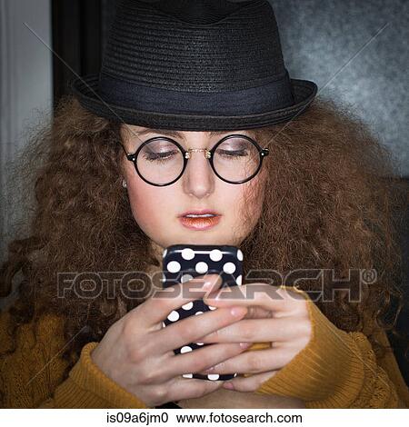 Stock Image - Woman using cell phone. Fotosearch