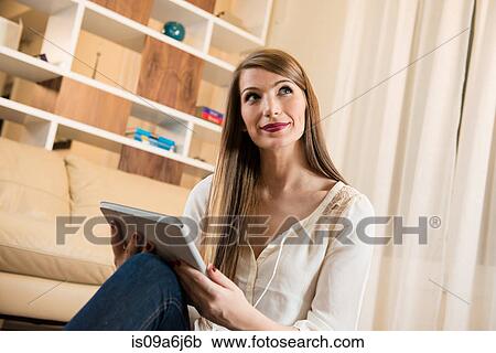 Stock Image - Woman using tablet computer. Fotosearch