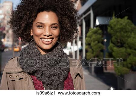 Woman walking on city street View Large Photo Image Stock Image - Woman walking on city street. Fotosearch