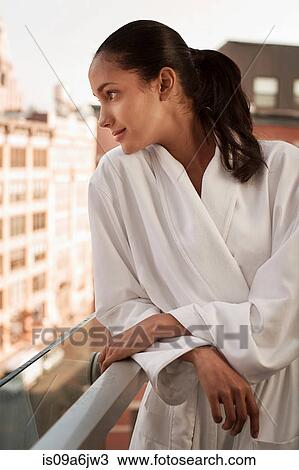 Woman wearing bathrobe on balcony View Large Photo Image Stock Image - Woman wearing bathrobe on balcony. Fotosearch