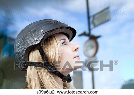 Woman wearing bicycle helmet outdoors View Large Photo Image Stock Image - Woman wearing bicycle helmet outdoors. Fotosearch