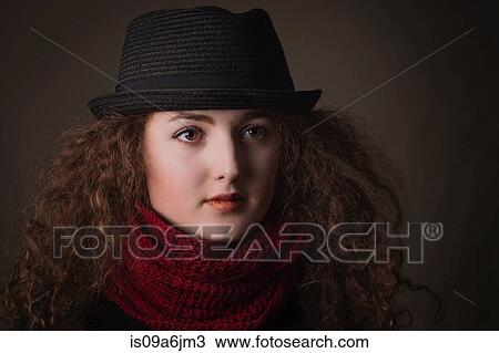 Stock Image - Woman wearing hat and scarf. Fotosearch