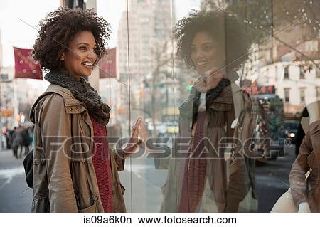 Woman window shopping on city street View Large Photo Image Picture - Woman window shopping on city street. Fotosearch