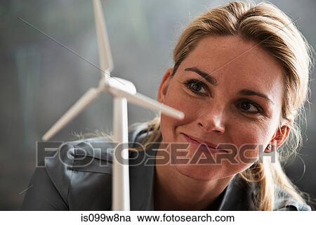 Woman with model wind turbine View Large Photo Image Stock Image - Woman with model wind turbine. Fotosearch