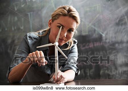 Woman with model wind turbine View Large Photo Image Stock Photo - Woman with model wind turbine. Fotosearch