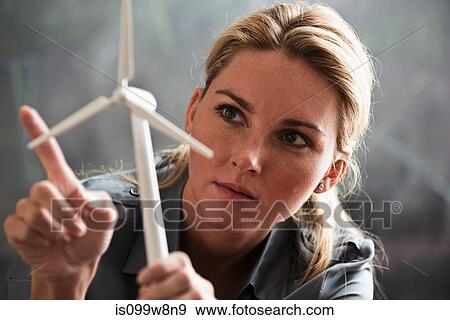 Woman with model wind turbine View Large Photo Image Stock Photo - Woman with model wind turbine. Fotosearch