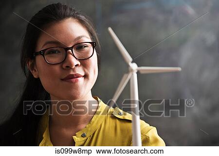 Stock Photography - Woman with model wind turbine. Fotosearch