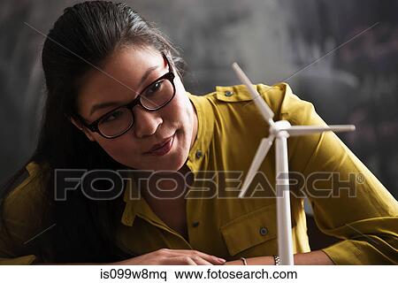 Woman with model wind turbine View Large Photo Image Stock Photography - Woman with model wind turbine. Fotosearch