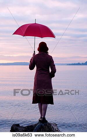 Woman with umbrella admiring rural lake View Large Photo Image Stock Image - Woman with umbrella admiring rural lake. Fotosearch