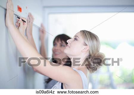 Stock Photo - Woman working with interior designer. Fotosearch
