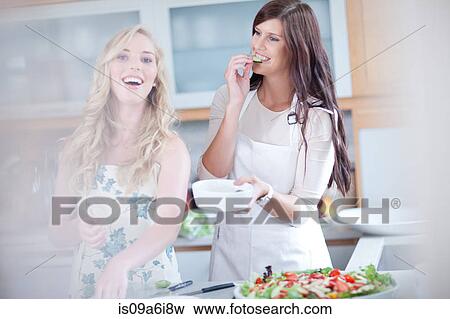 Women cooking together in kitchen View Large Photo Image Stock Photo - Women cooking together in kitchen. Fotosearch