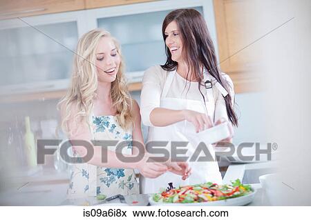 Women cooking together in kitchen View Large Photo Image Stock Photo - Women cooking together in kitchen. Fotosearch