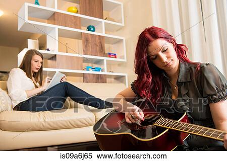 Women relaxing in living room View Large Photo Image Stock Photography - Women relaxing in living room. Fotosearch
