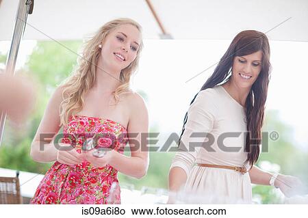 Women setting table outdoors View Large Photo Image Picture - Women setting table outdoors. Fotosearch
