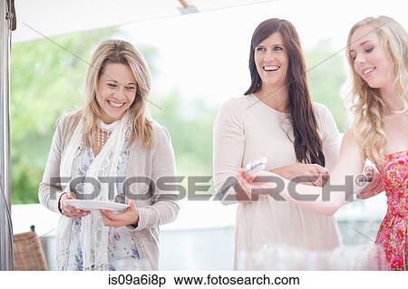 Women setting table outdoors View Large Photo Image Stock Photography - Women setting table outdoors. Fotosearch