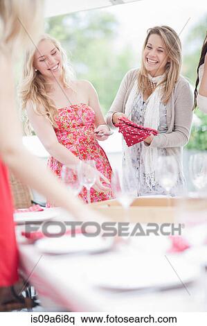 Women setting table outdoors View Large Photo Image Stock Photography - Women setting table outdoors. Fotosearch