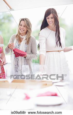 Stock Photography - Women setting table outdoors. Fotosearch